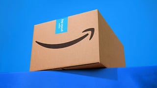 A cardboard Amazon Prime Box against a blue background.