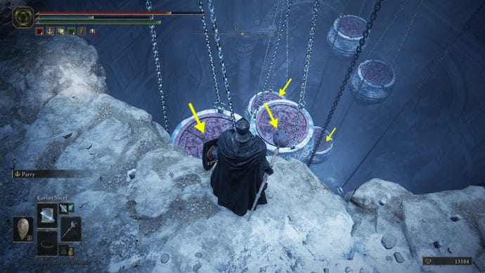 A Tarnished stands by a cliff overlooking several jars hanging from chains in Belurat Gaol in Elden Ring: Shadow of the Erdtree. Yellow arrows show a path to jump.